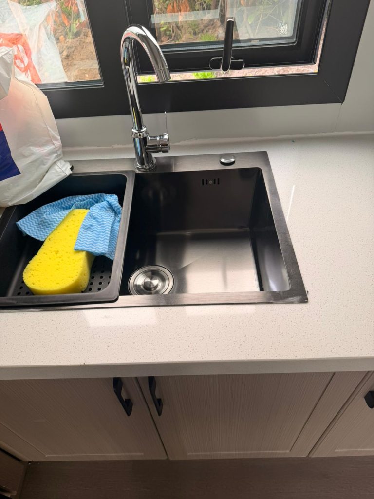 Contemporary sink and kitchen workspace inside a 2 bedroom modular home in Limerick